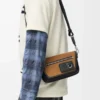 Bolso mensajero Mini Flex en lona y ante Negro/Oro oscuro