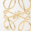 Broche Anagram en metal dorado Broche Anagram en metal dorado