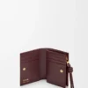 Cartera compacta con nudo en anguila burdeos oscuro Cartera compacta con nudo en anguila burdeos oscuro