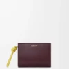 Cartera compacta con nudo en piel de becerro napa brillante Burdeos oscuro/Citrino claro Cartera compacta con nudo en piel de becerro napa brillante Burdeos oscuro/Citrino claro