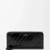 Cartera con cremallera alrededor y nudo en piel de anguila. Negro