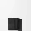Funda para pasaporte Puzzle en piel de becerro granulada flexible. Color negro.