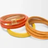 Pulsera doble trenzada en piel de becerro Naranja vivo/Amarillo Pulsera doble trenzada en piel de becerro Naranja vivo/Amarillo